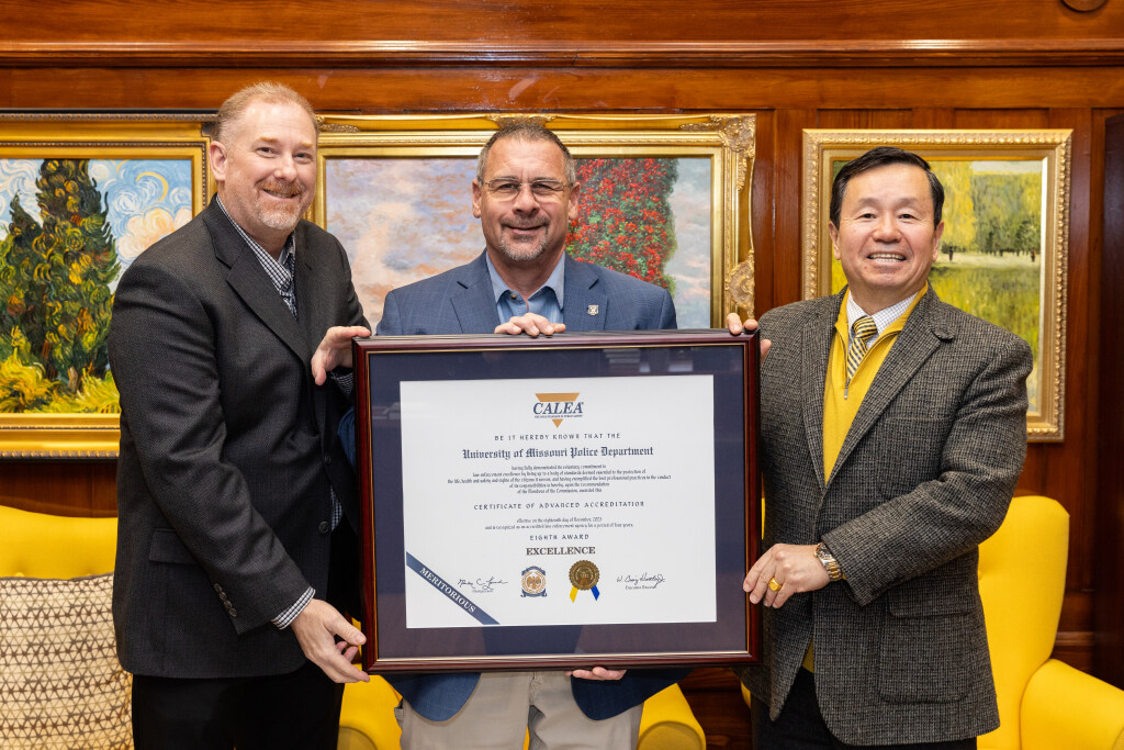 President Choi presents Chief Brian Weimer and Sergeant Dennis Stroer with the department's eighth CALEA award.